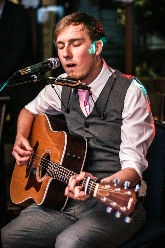 Groom plays the acoustic guitar while singing Dustin Kensue best wedding speech